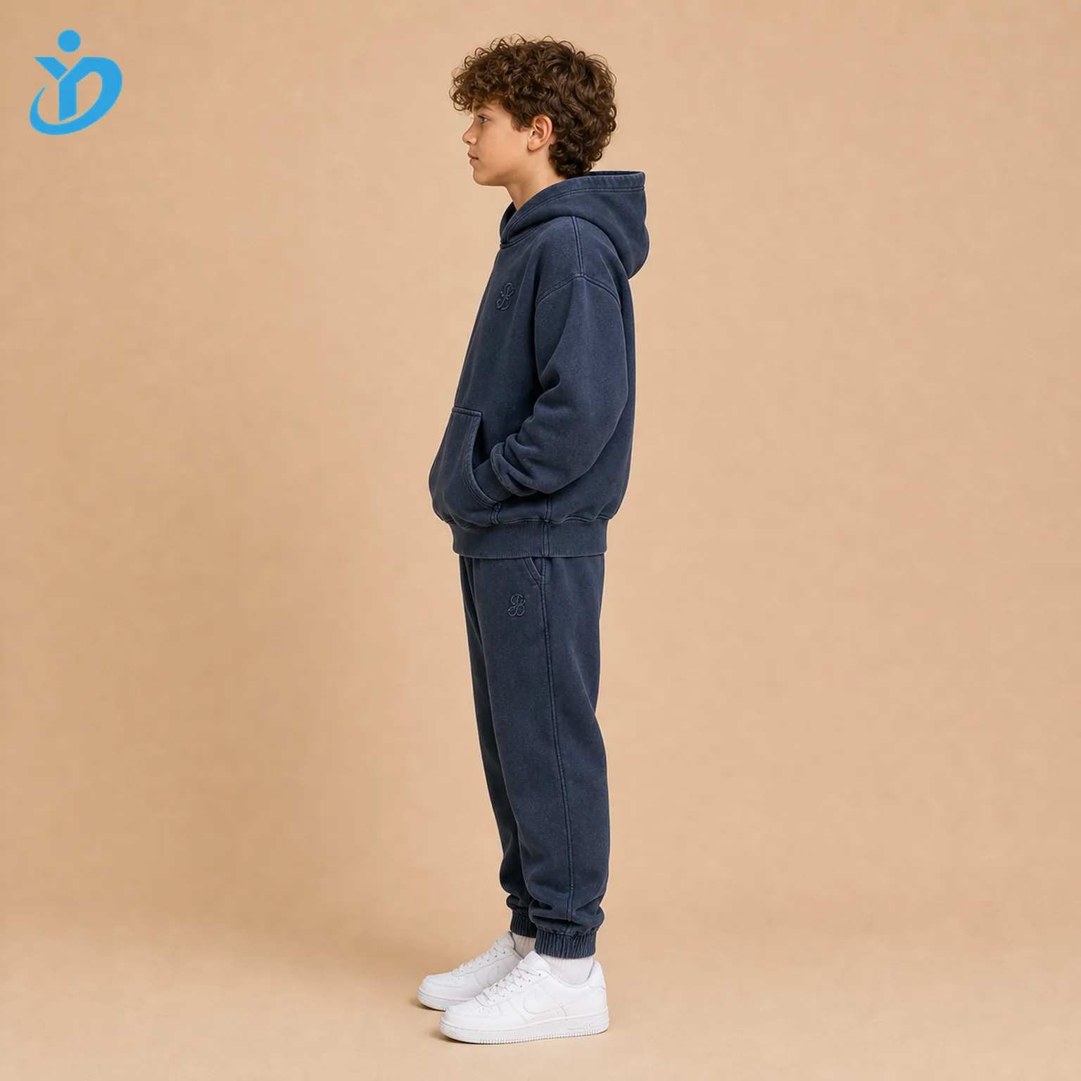 Custom boys embroidered tracksuit set side view with washed navy hoodie, jogger pants, premium embroidered logo, garment wash soft hand feel and Dongguan Yidi Clothing Co Ltd transparent logo.