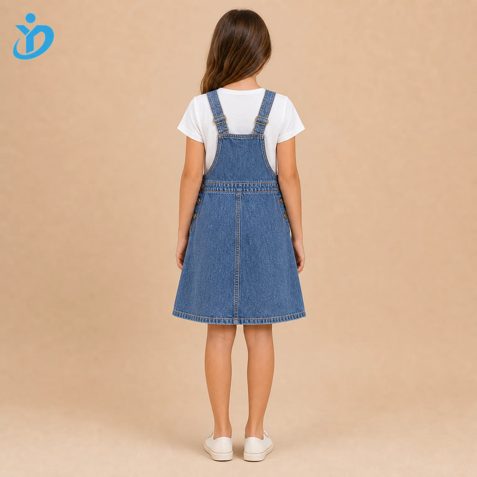 Full body back view of custom girls denim pinafore dress with adjustable straps, stone wash blue denim, contrast stitching, A-line skirt and Dongguan Yidi Clothing Co Ltd transparent logo