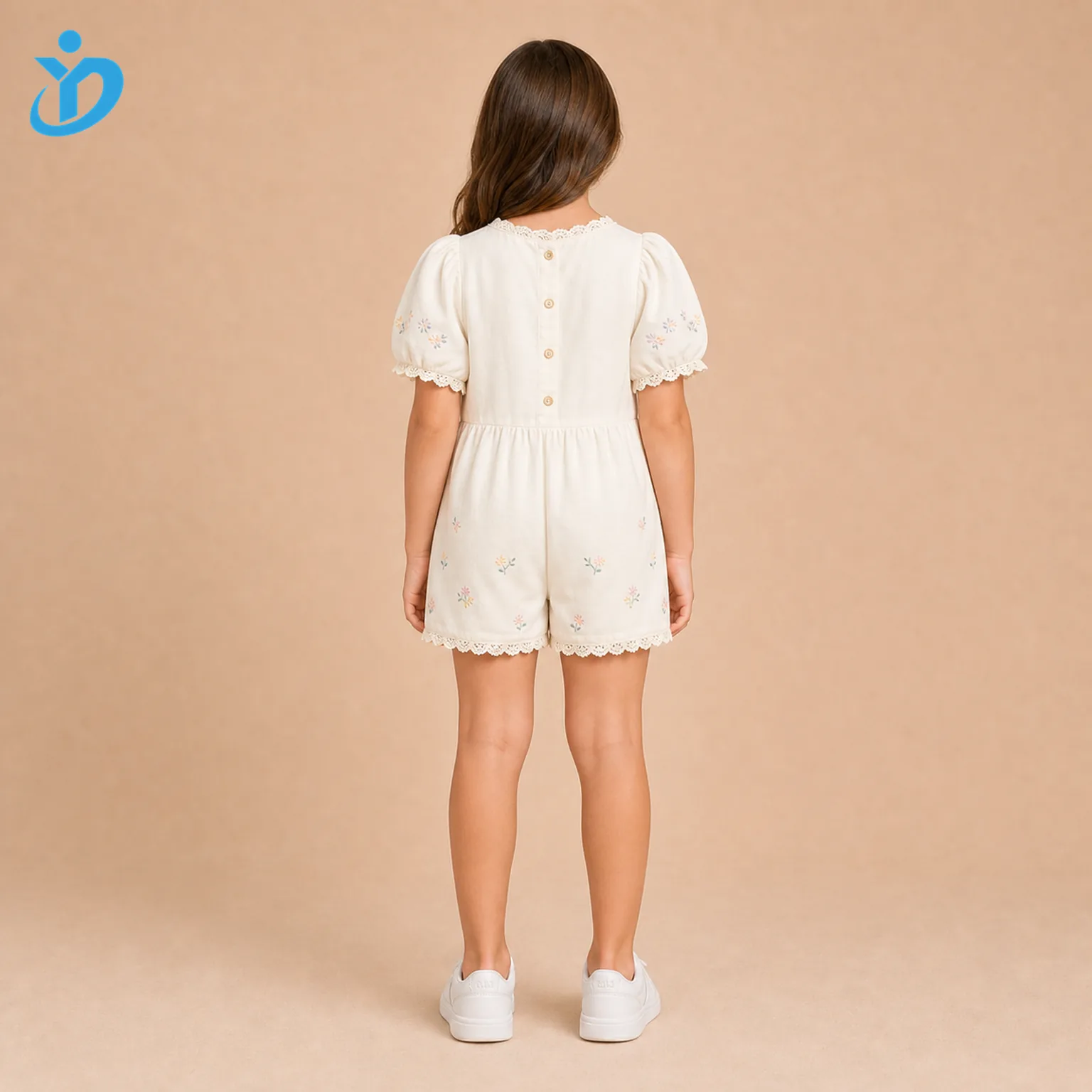 Custom girls puff sleeve embroidered romper back view with back button closure, ivory cotton fabric, lace trim, puff sleeves and Dongguan Yidi Clothing Co Ltd transparent logo.