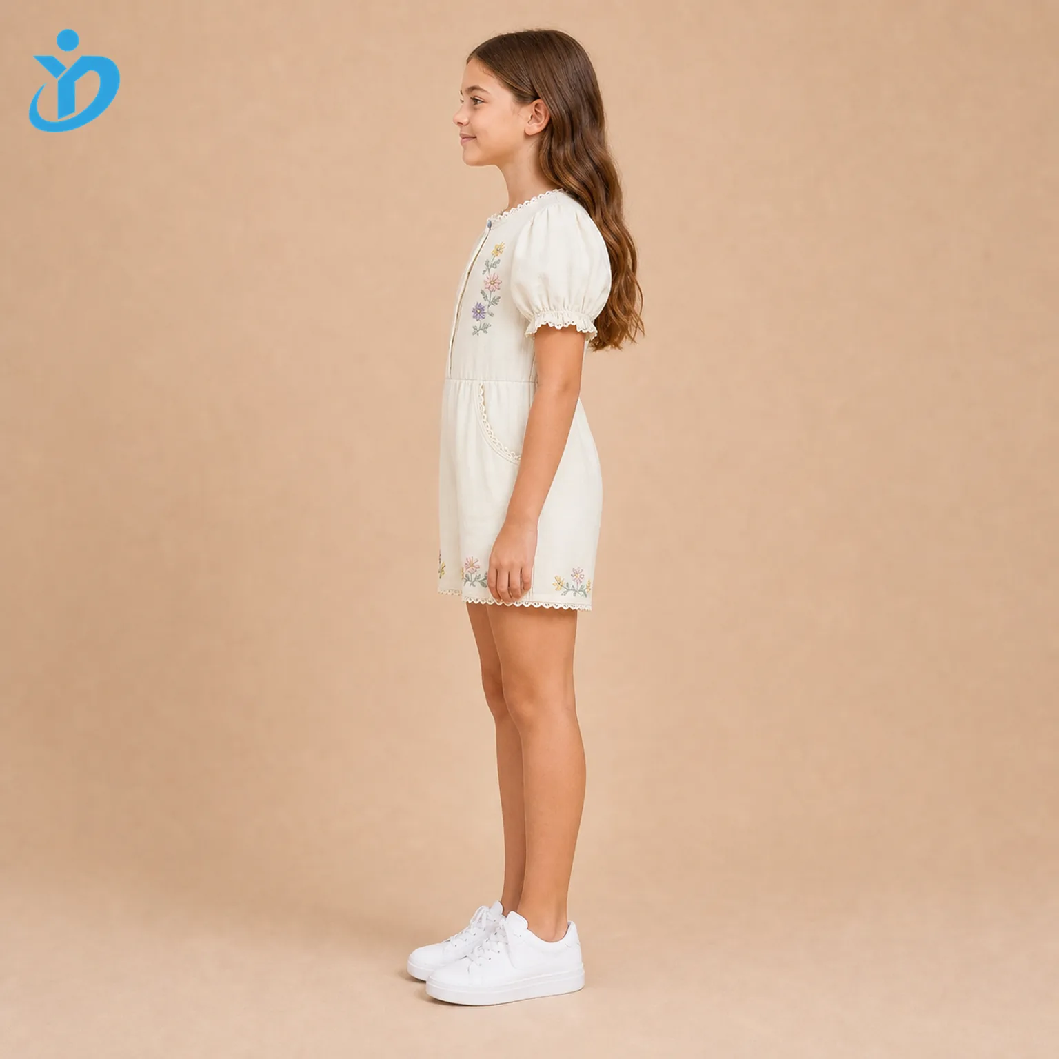 Custom girls puff sleeve embroidered romper side view with ivory cotton fabric, floral embroidery, lace trim, puff sleeves and Dongguan Yidi Clothing Co Ltd transparent logo.