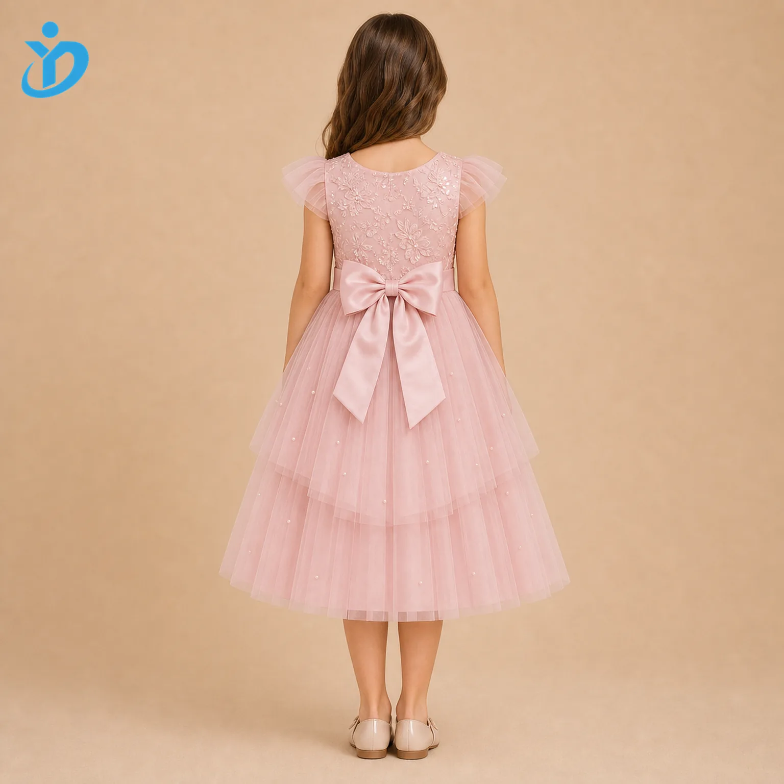 Full body back view of custom girls tulle princess dress with large satin bow, layered pink tulle skirt, embroidered bodice, pearl decoration and Dongguan Yidi Clothing Co Ltd transparent logo