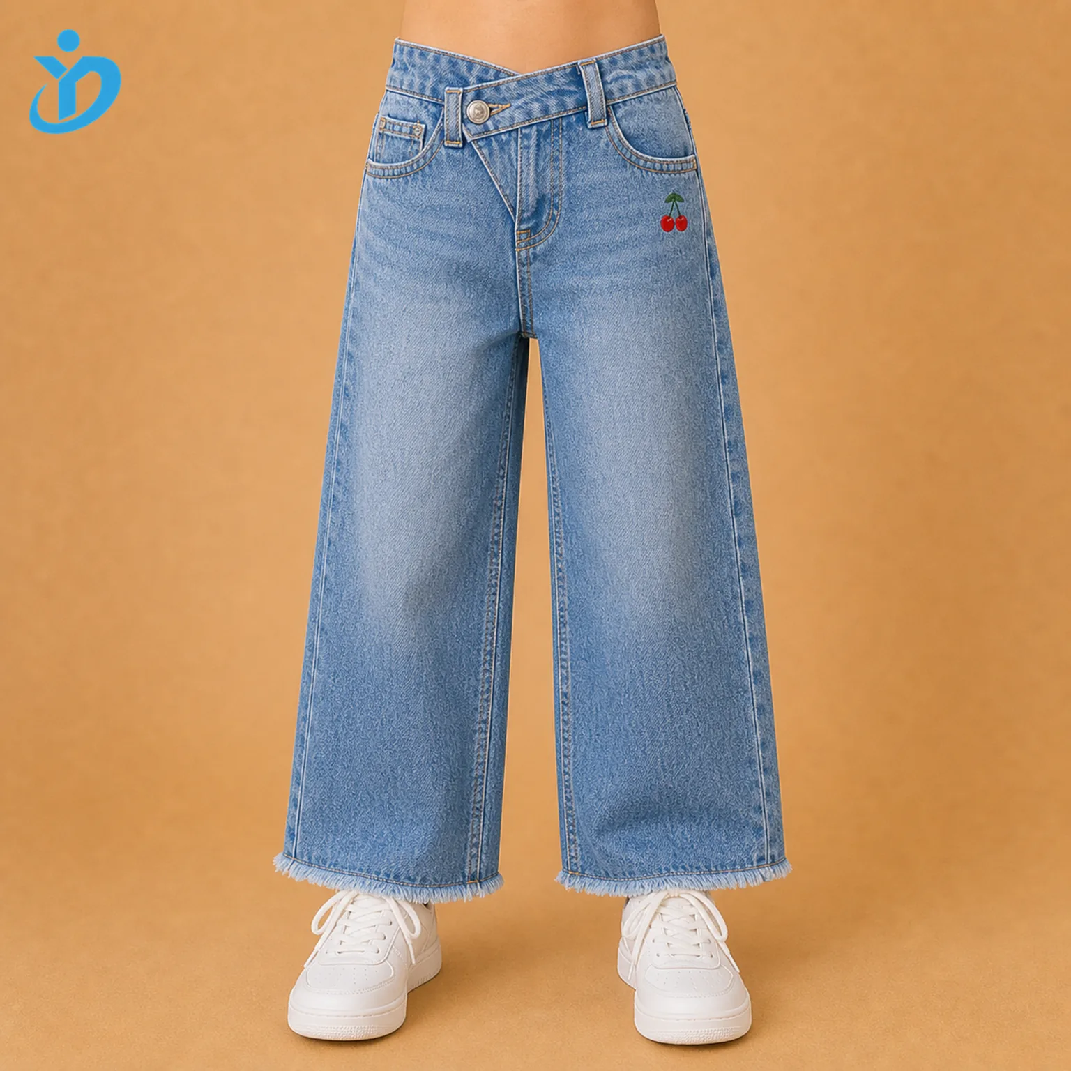 Lower body front view of custom girls wide leg denim jeans with vintage medium blue snow wash, crossover waistband, small cherry detail, raw frayed safe-length hem and Dongguan Yidi Clothing Co Ltd transparent logo