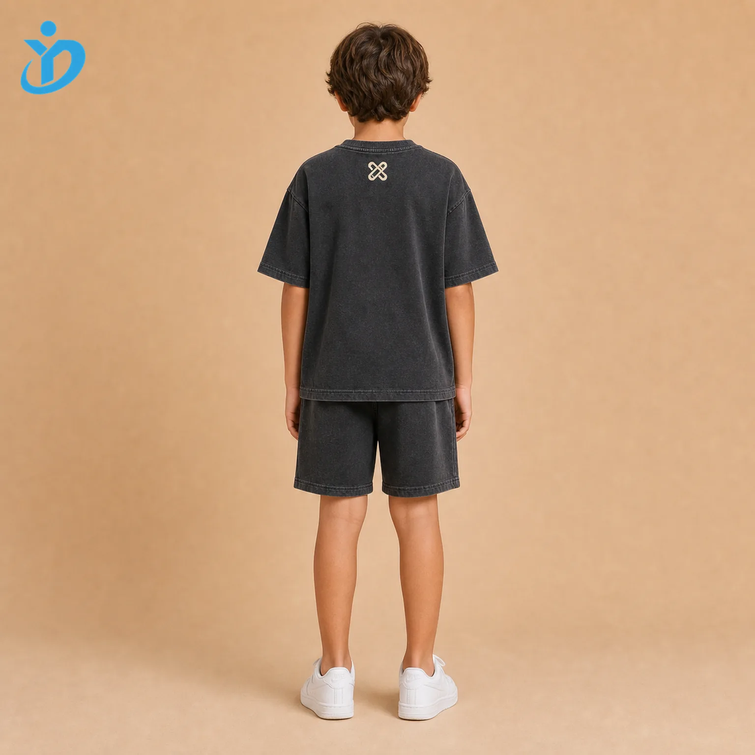 Custom kids 3D puff print T-shirt and shorts set back view with washed charcoal black streetwear fabric, raised cream puff print and Dongguan Yidi Clothing Co Ltd transparent logo.