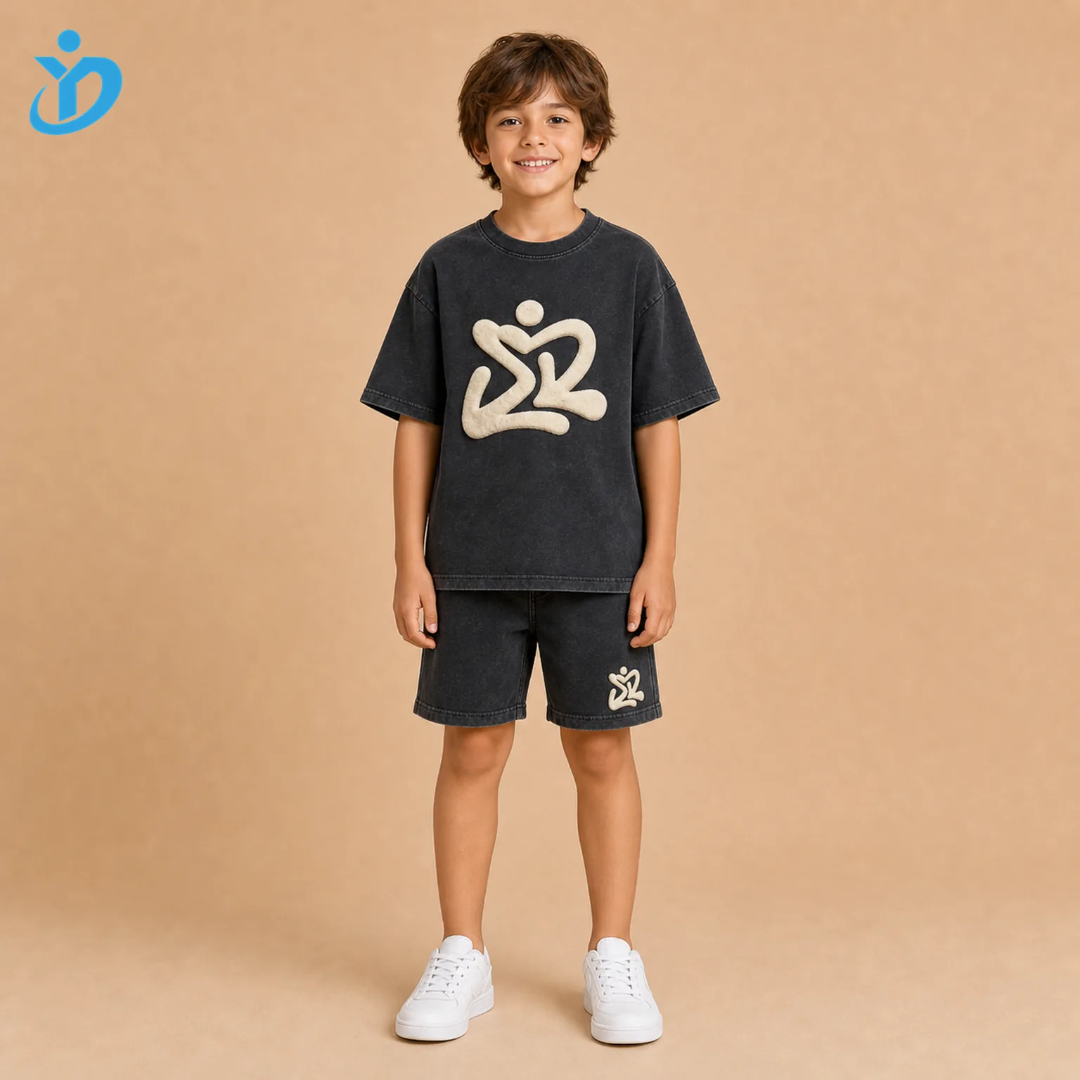 Custom kids 3D puff print T-shirt and shorts set front view with washed charcoal black streetwear fabric, raised cream puff print and Dongguan Yidi Clothing Co Ltd transparent logo.