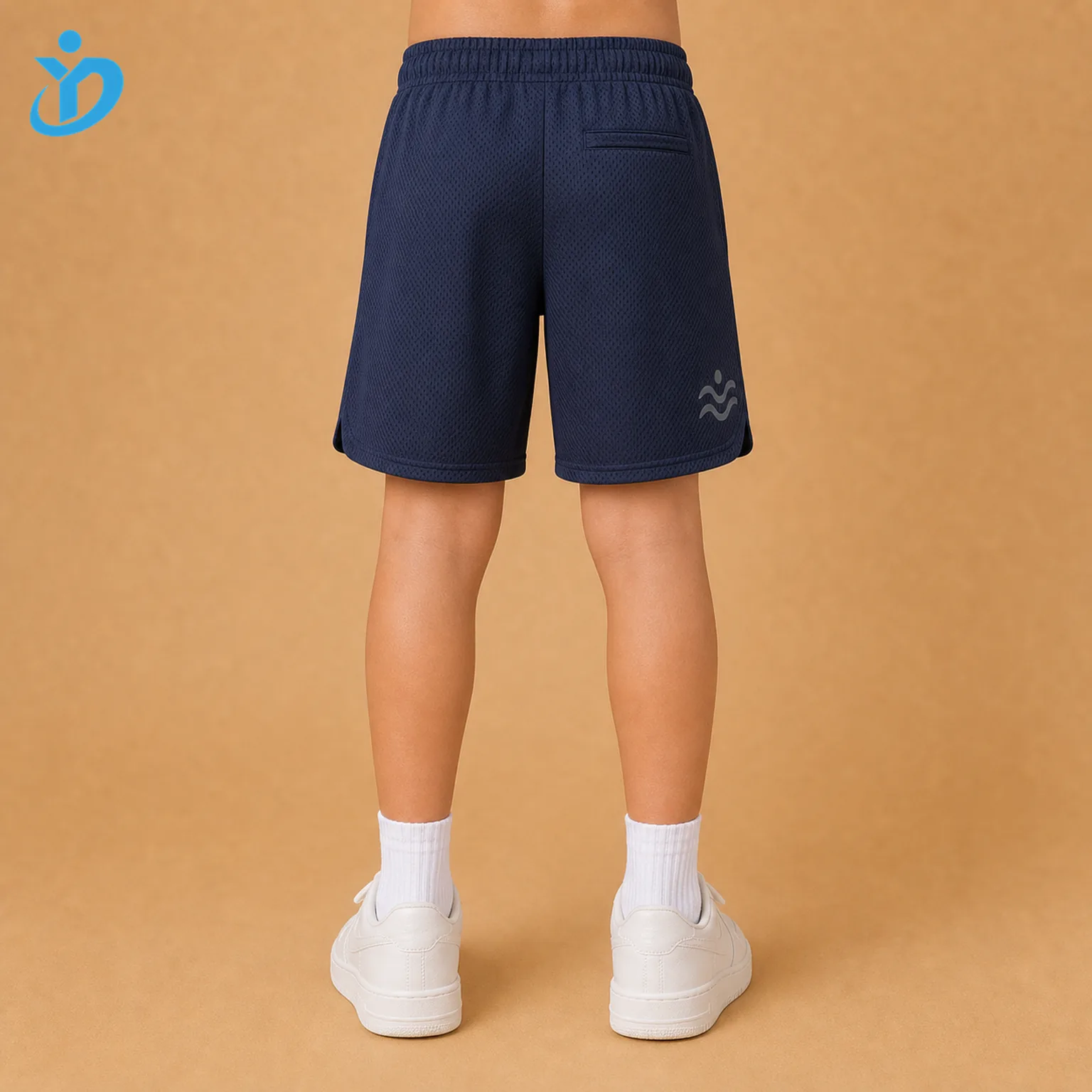 Lower body back view of custom kids athletic shorts with navy recycled polyester mesh, moisture wicking fabric, heat transfer detail and Dongguan Yidi Clothing Co Ltd transparent logo