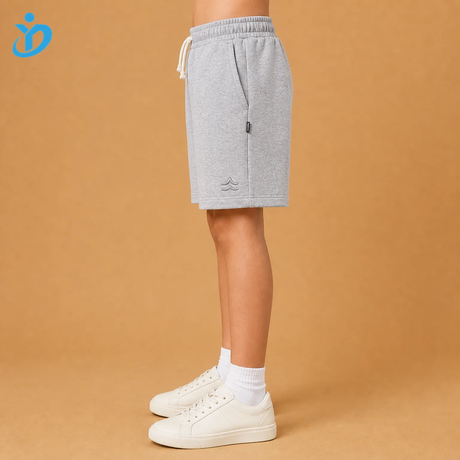 Lower body side view of custom kids French terry shorts showing relaxed fit, side pocket, woven label tab, tonal embroidery and Dongguan Yidi Clothing Co Ltd transparent logo