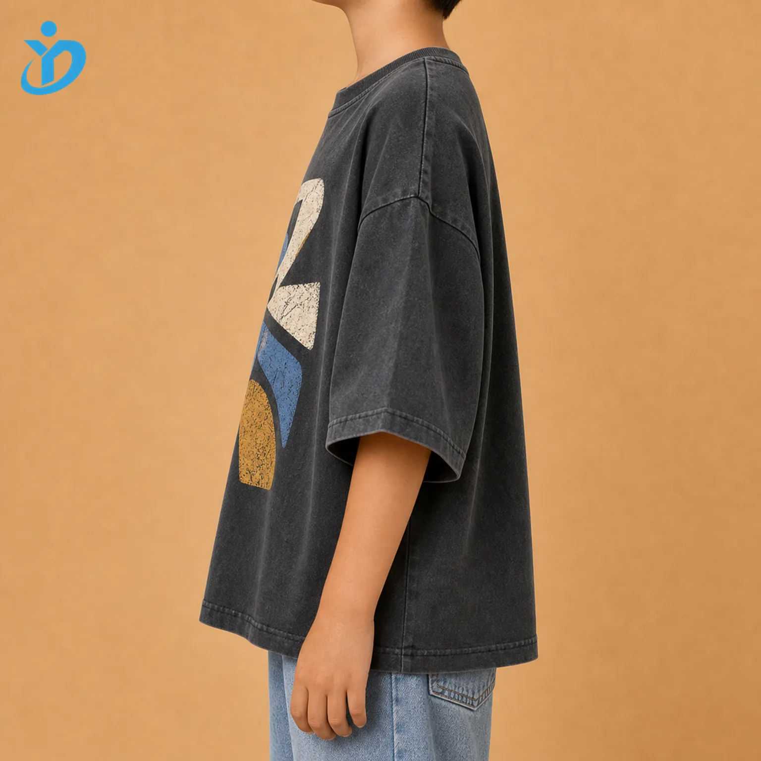 Upper body side view of custom kids oversized graphic T shirt showing washed charcoal fabric drop shoulder wide sleeve large crack print graphic edge unisex fit and Dongguan Yidi Clothing Co Ltd transparent logo