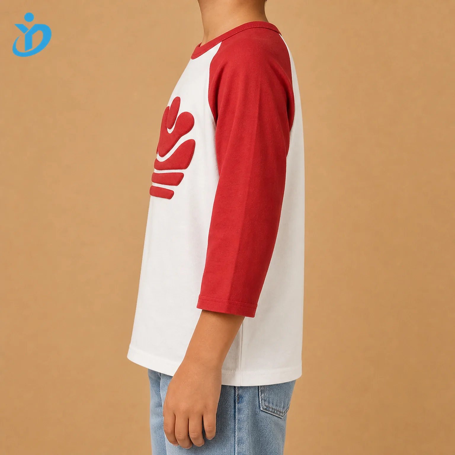 Upper body side view of custom kids raglan baseball T shirt showing white body red contrast raglan sleeve side seam raised puff print edge unisex kids fit and Dongguan Yidi Clothing Co Ltd transparent logo