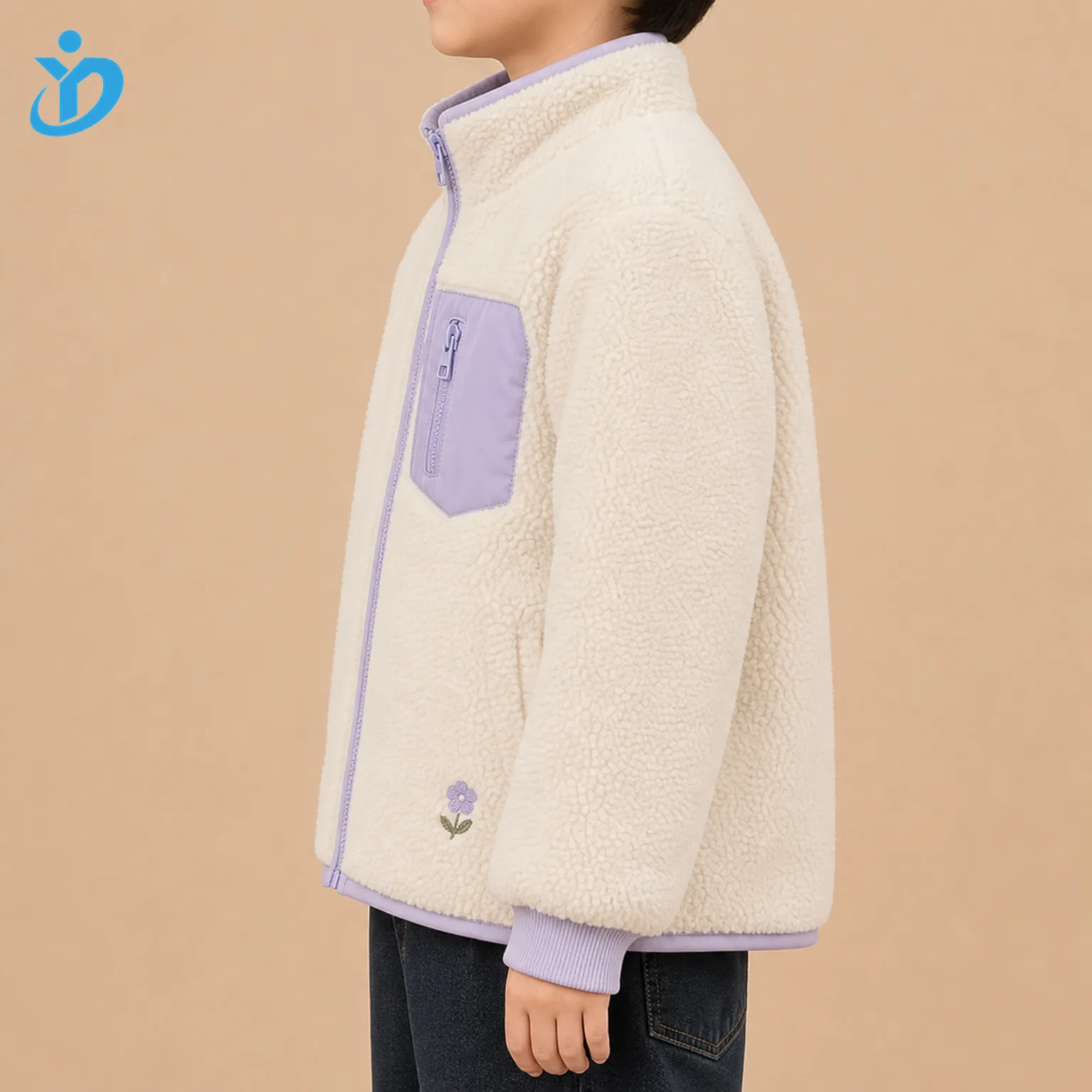 Upper body side view of custom kids teddy fleece jacket showing cream teddy fleece, lavender contrast pocket, zipper edge, chin guard, elastic binding, ribbed cuff, small flower embroidery and Dongguan Yidi Clothing Co Ltd transparent logo