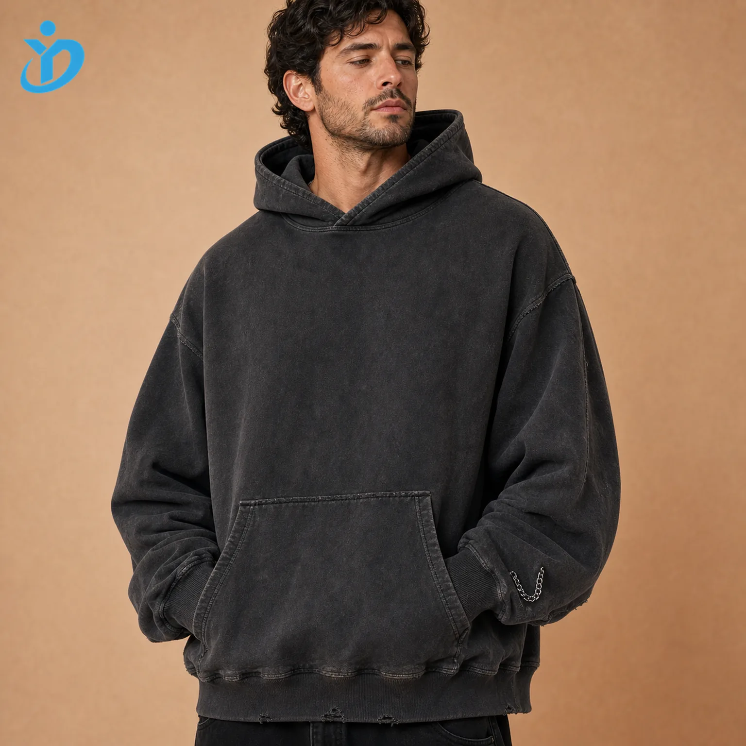 Upper body front view of custom mens boxy vintage washed hoodies in charcoal black with short wide boxy fit ultra dropped shoulder no drawcord double-layer hood raw edge distressing and Dongguan Yidi Clothing Co Ltd transparent logo