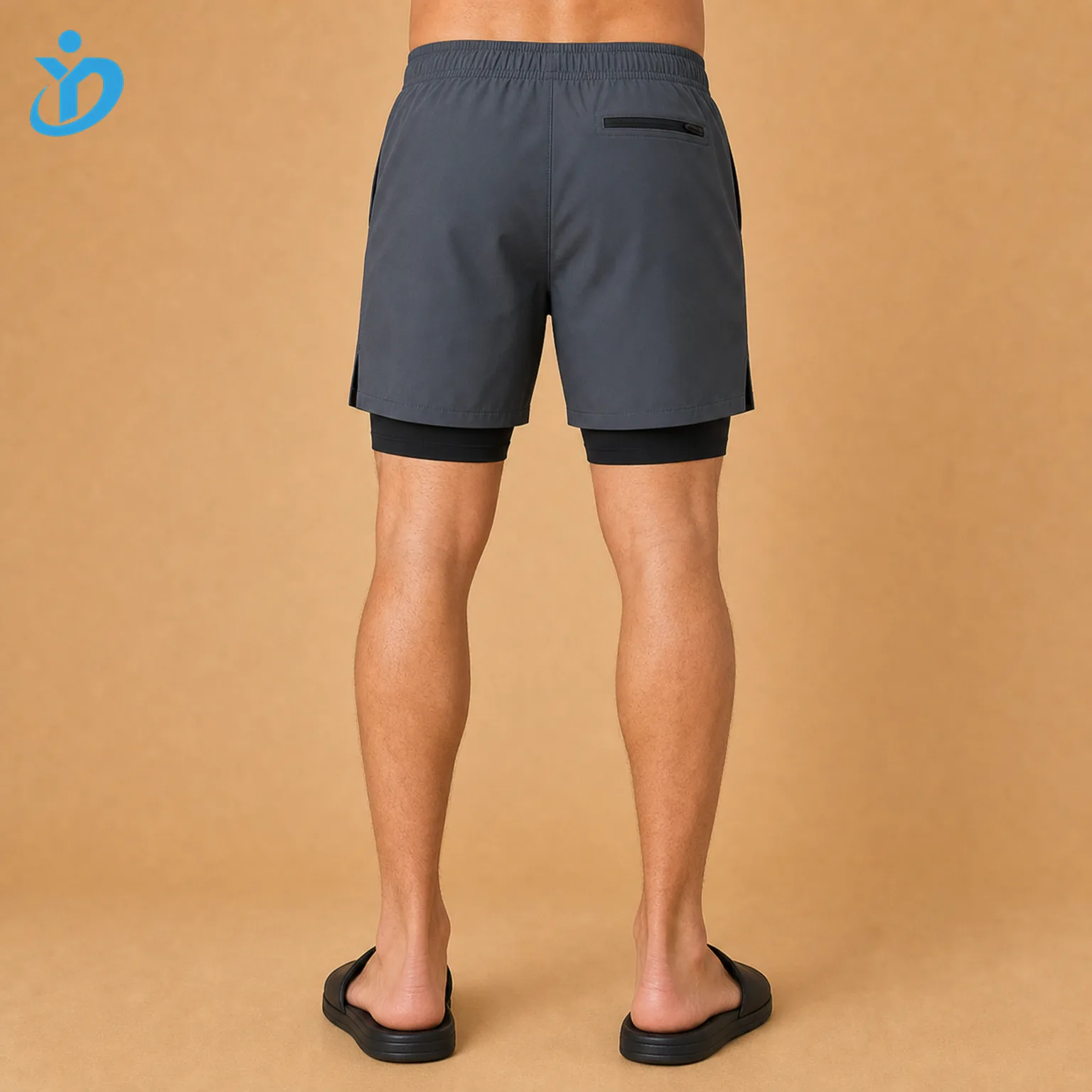 Lower body back view of custom mens compression liner swim shorts with graphite gray quick dry outer shorts black compression liner hidden pocket detail and Dongguan Yidi Clothing Co Ltd transparent logo