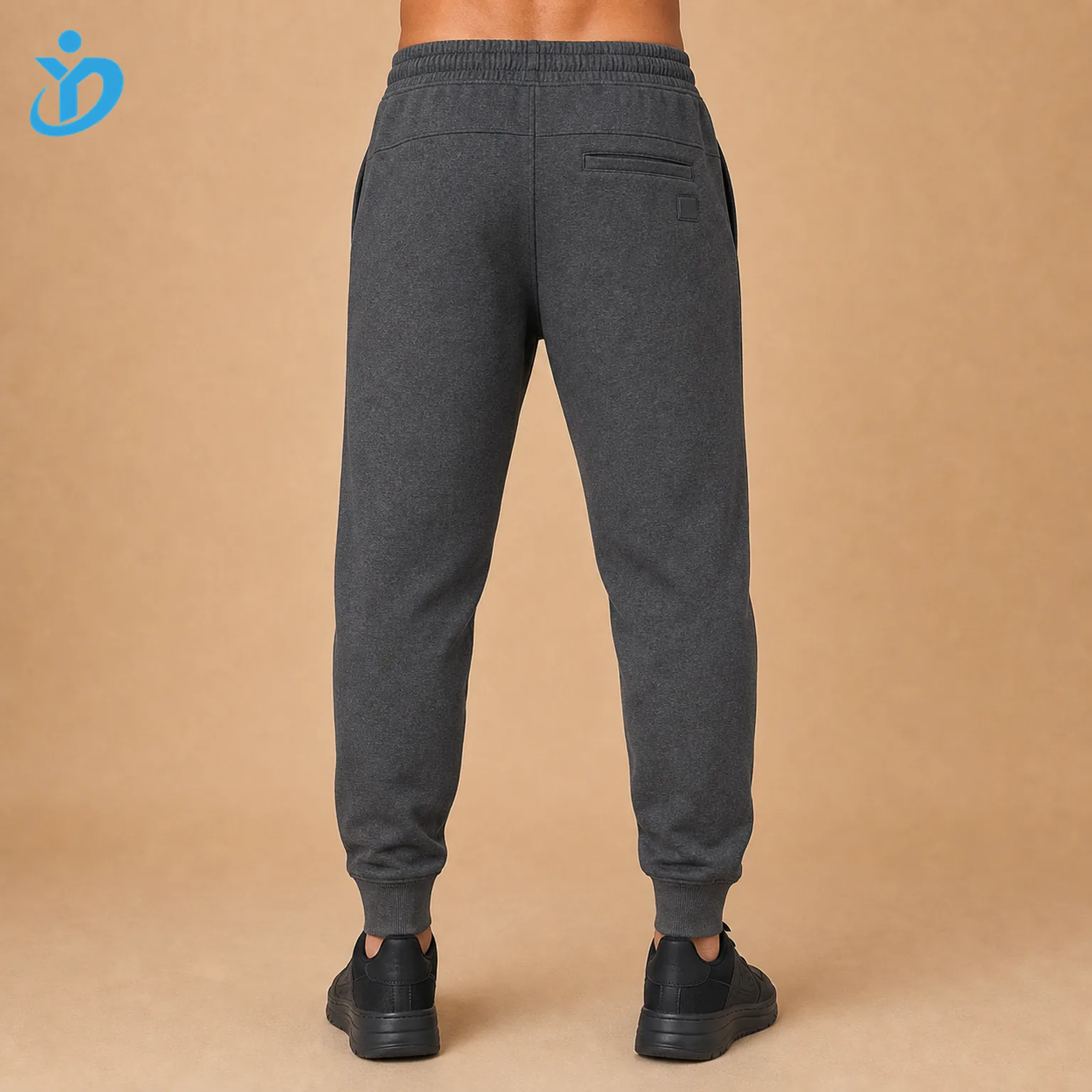 Lower body back view of custom mens heather charcoal fleece jogger pants showing back pocket rib cuffs elastic waistband tapered fit French Terry texture and Dongguan Yidi Clothing Co Ltd transparent logo