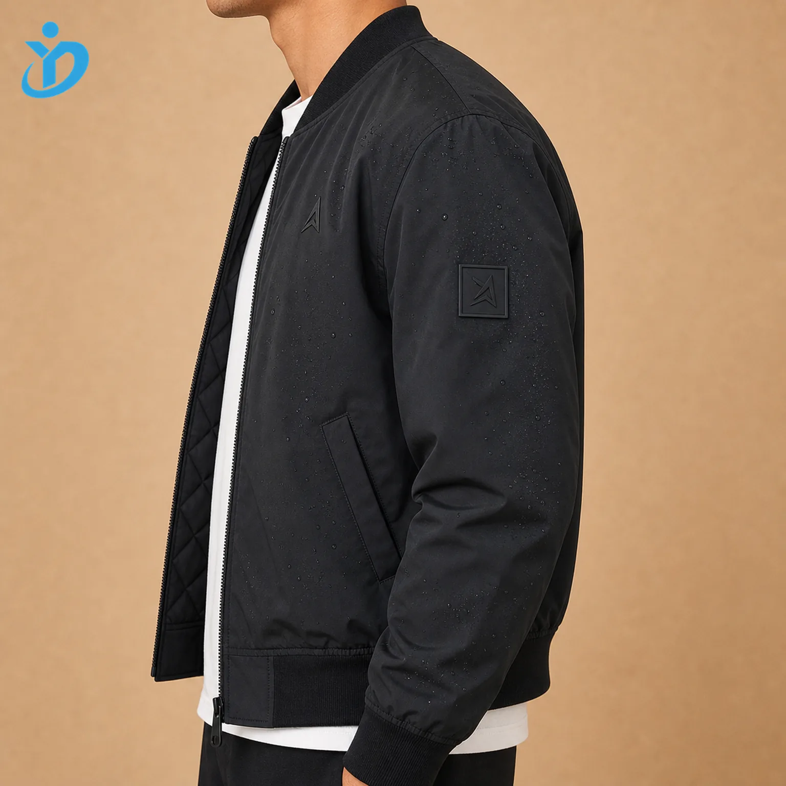 Upper body side view of custom mens recycled nylon bomber jacket showing water repellent black nylon shell silicone sleeve patch ribbed hem side pocket quilted lining edge and Dongguan Yidi Clothing Co Ltd transparent logo