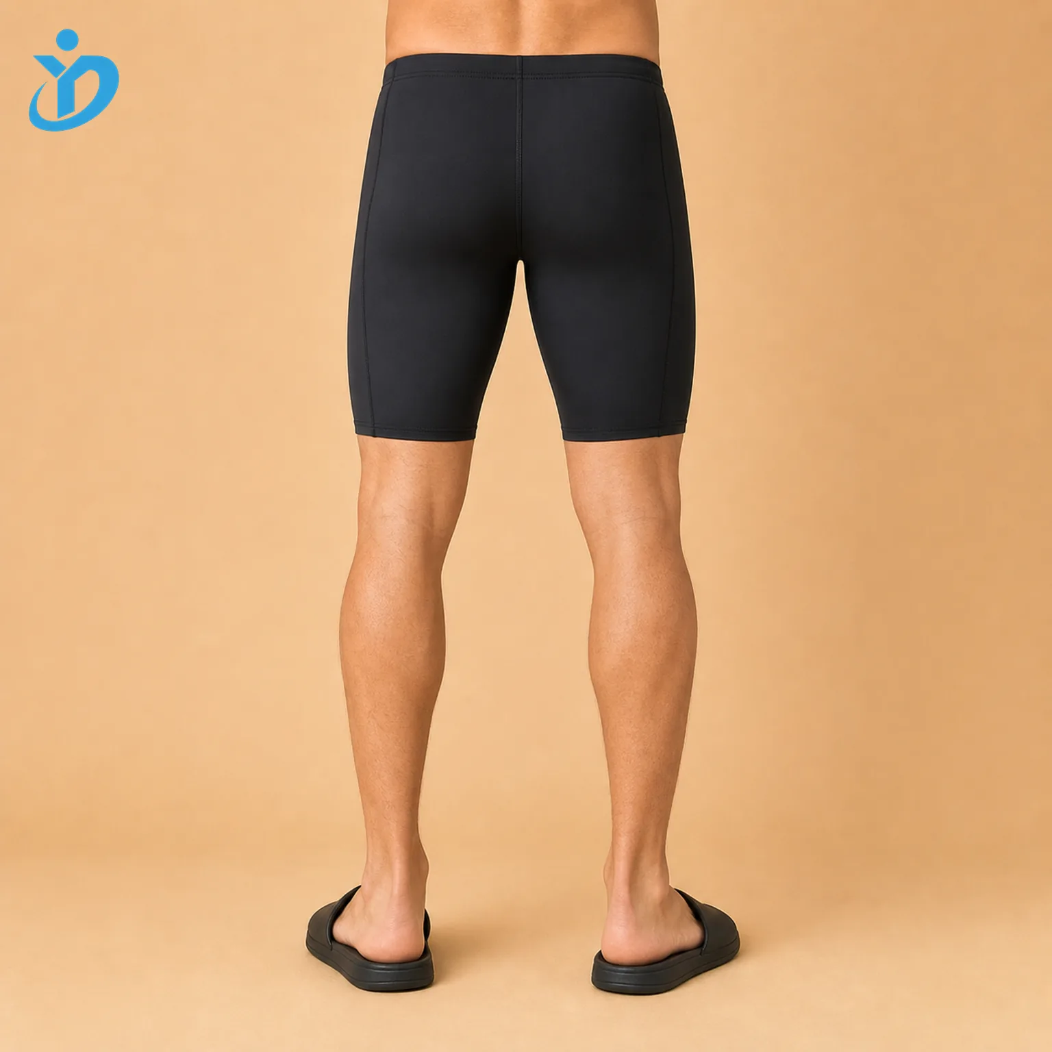 Lower body back view of custom mens swim jammers with black chlorine resistant UPF50 plus swim fabric compression fit flatlock seam panels and Dongguan Yidi Clothing Co Ltd transparent logo