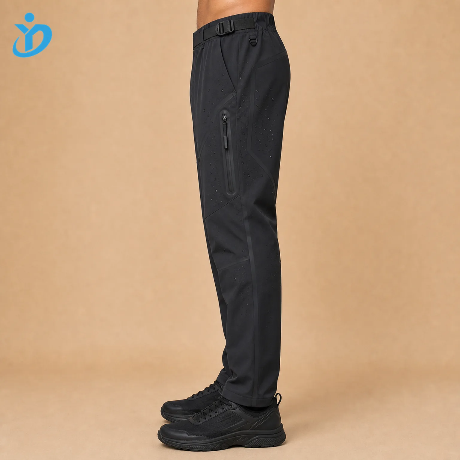 Lower body side view of custom mens waterproof techwear pants showing nylon spandex shell waterproof zipper pocket bonded seam tape laser cut panel adjustable waist tab tapered leg and Dongguan Yidi Clothing Co Ltd transparent logo