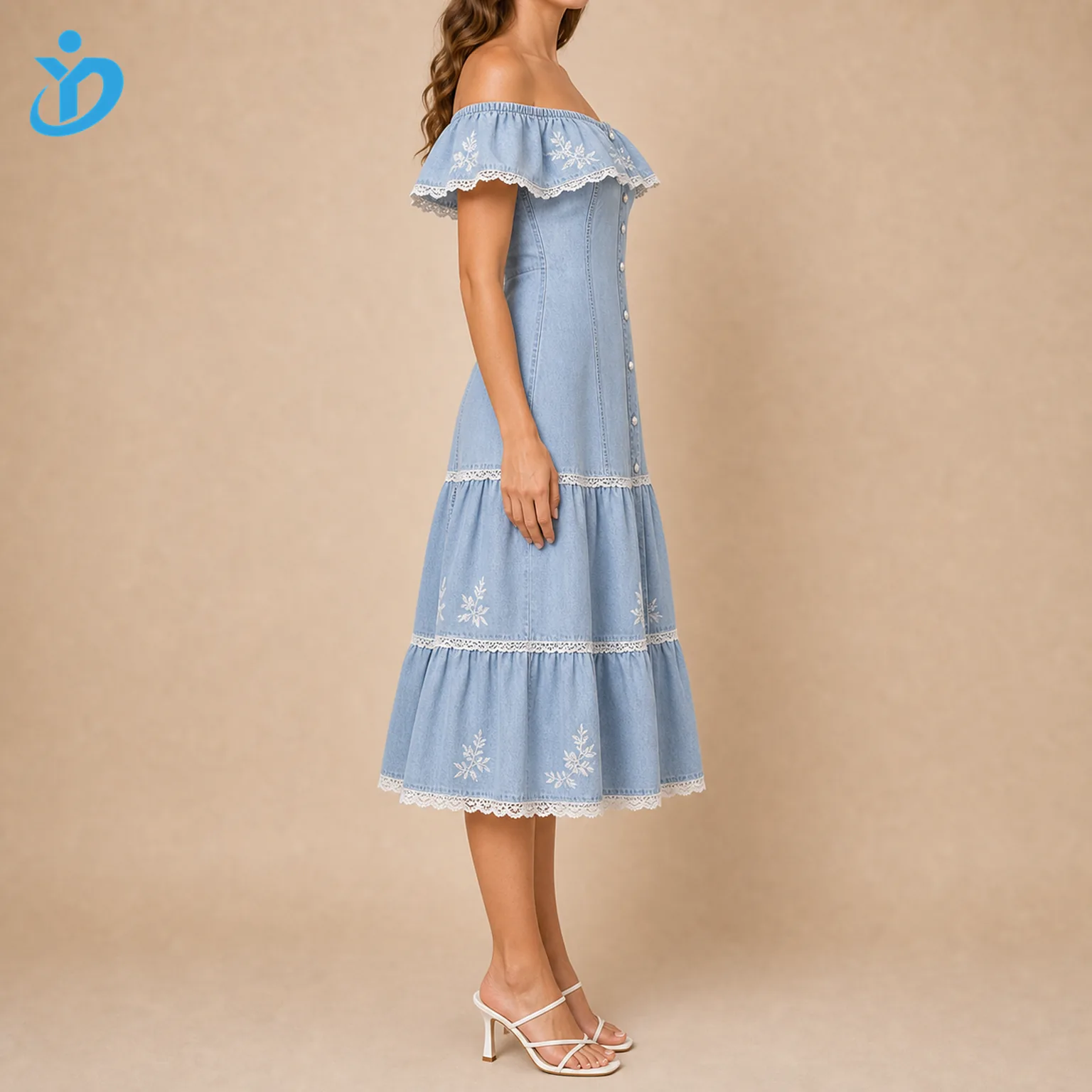 Custom womens light wash denim ruffle dress side view showing off shoulder ruffle sleeve tiered skirt lace trim pearl buttons and Dongguan Yidi Clothing Co Ltd transparent logo