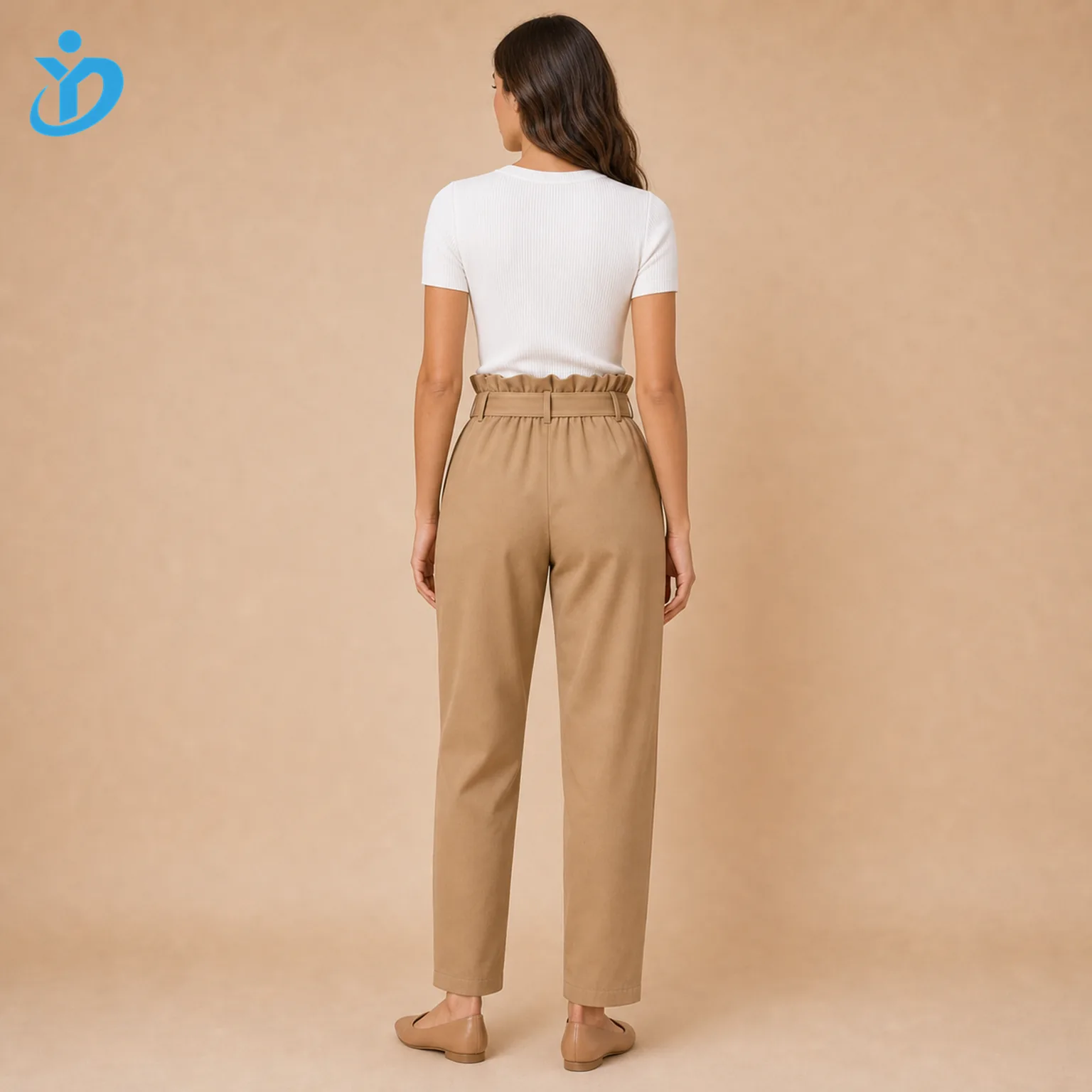 Custom womens paperbag waist pants back view showing elastic paperbag waist self fabric belt tapered leg camel woven fabric white top tan flats and Dongguan Yidi Clothing Co Ltd transparent logo
