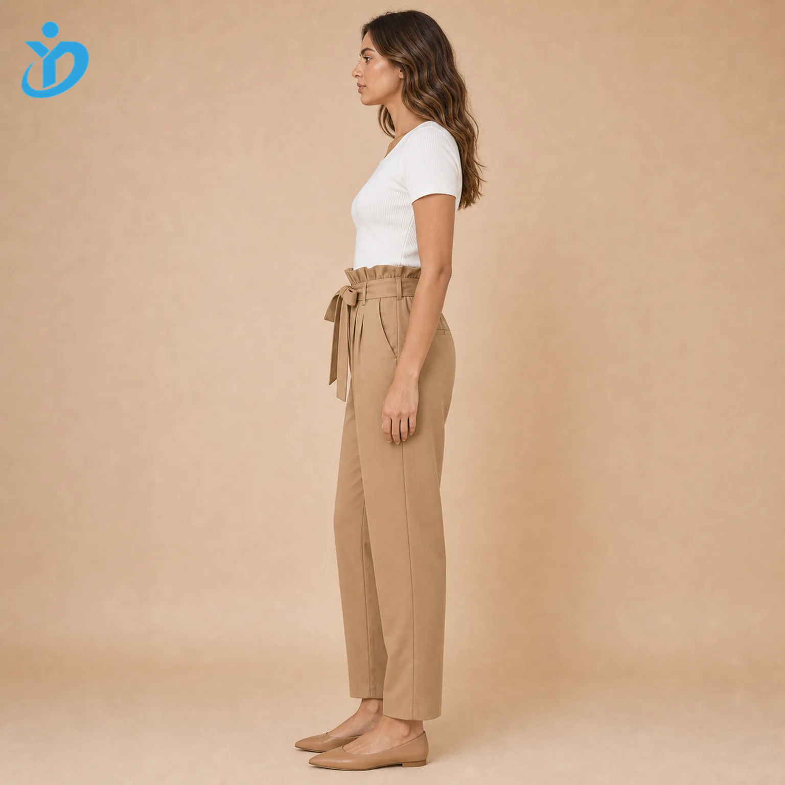 Custom womens paperbag waist pants side view showing paperbag waist self fabric belt elastic waist tapered leg side pocket white top tan flats and Dongguan Yidi Clothing Co Ltd transparent logo