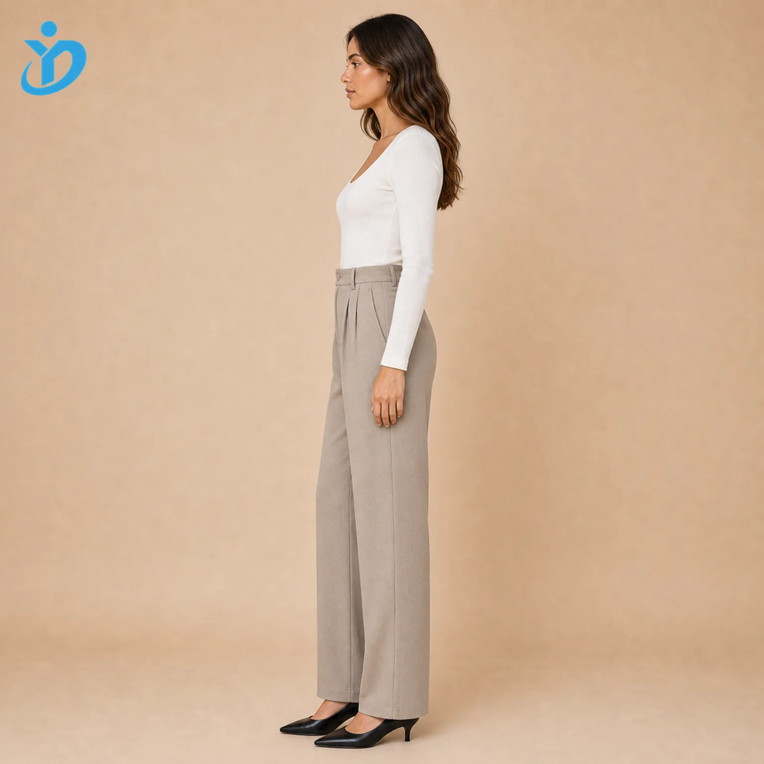 Custom womens straight leg pants side view showing straight leg cut front pleats side pockets elastic back waist white top black heels and Dongguan Yidi Clothing Co Ltd transparent logo